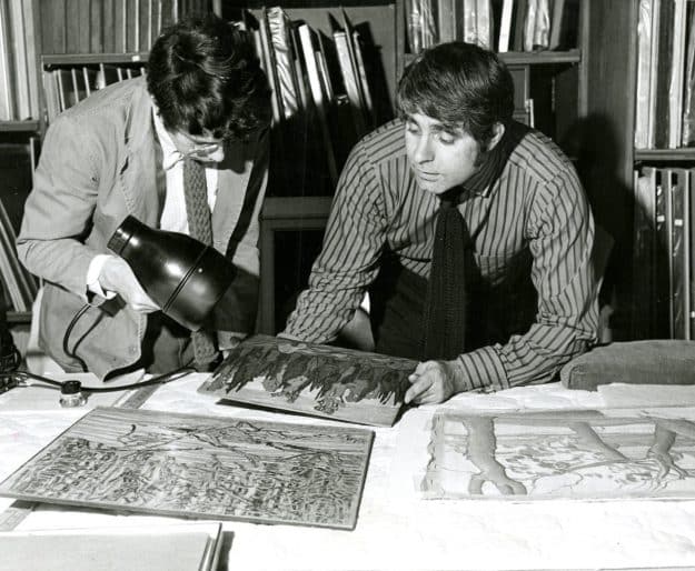 Ralph Allen, Director, and Bill Muyssen, Assistant Curator, examining gifts from the estate of Douglas Duncan, 1971