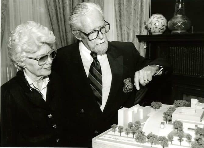 Mary and John Robertson, donors, examine gallery building model, 1997