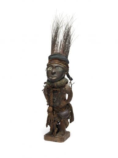 Yombe peoples, Democratic Republic of the Congo, Power Figure (Nkisi Nduda), 19th-20th century, wood, pigment, porcupine quills, resinous coating, mirror fragments, nails, iron, bells, cotton and plant fibres. Gift of Justin and Elisabeth Lang, 1984 (M84-356)