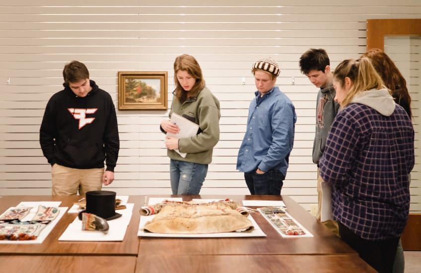 Students in ECON 244 view art objects in the David McTavish Art Study Room. Photo: Tim Forbes