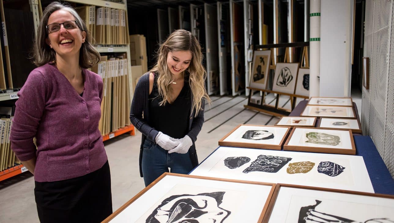 Curators Alicia Boutilier (left) and Alysha Strongman (right) look at prints in the Agnes vaults.
