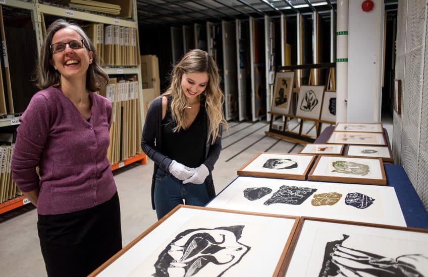 Curators Alicia Boutilier (left) and Alysha Strongman (right) look at prints in the Agnes vaults.
