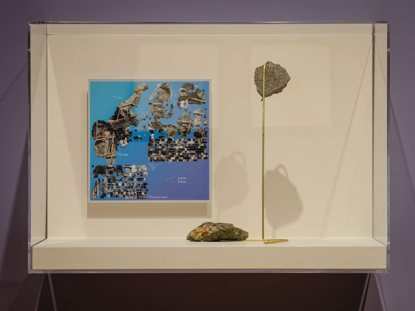 Jol Thoms, Isomorphis (redactor) and untitled sculpture, 2020, acrylic-mounted c-print and brass and rock sculpture with rock sourced from Dynamic Earth Sudbury. Collection of the artist