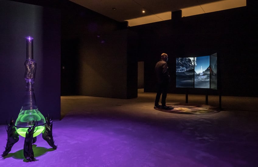Josèfa Ntjam, Luciferin Drop, 2020, glass, metal, plastic and Myceaqua Vitae, 2020, video with sound. Collection of the artist. Installation view from Drift: Art and Dark Matter. Photo: Tim Forbes