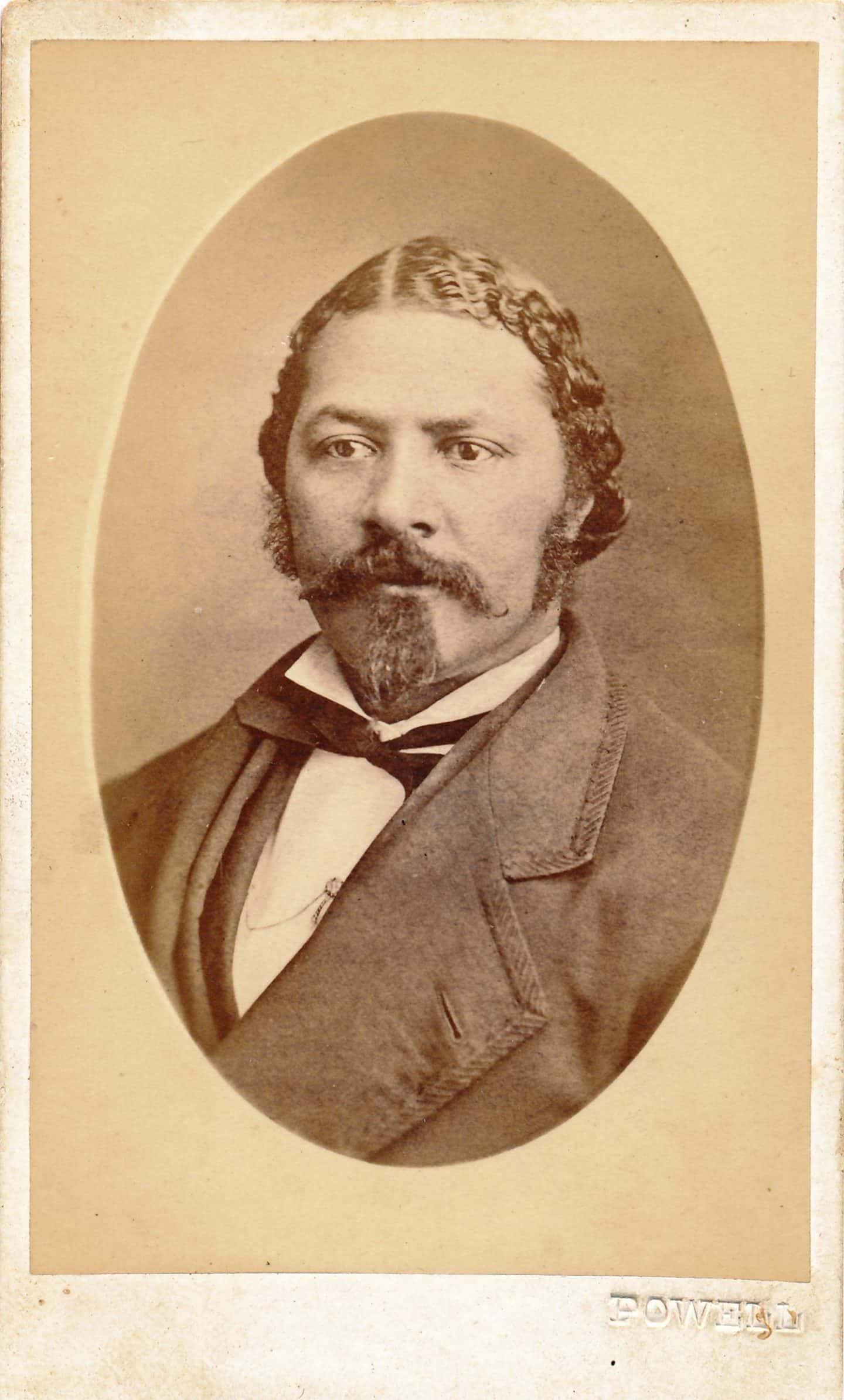Portrait photograph of Jim Johnson. The image is sepia toned and is round. Johnson wears a dark day coat with a bow tie.