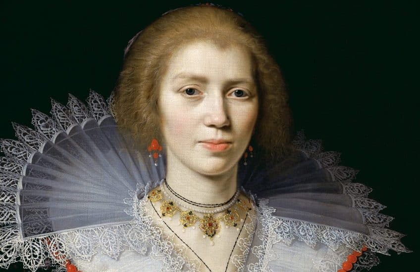 Unknown Artist, Portrait of a Woman (detail), around 1625, oil on canvas. Gift of Isabel Bader, 2021. A woman looks directly at the viewer with an elaborate white lace collar and red earrings. Her hair is pulled up behind her.