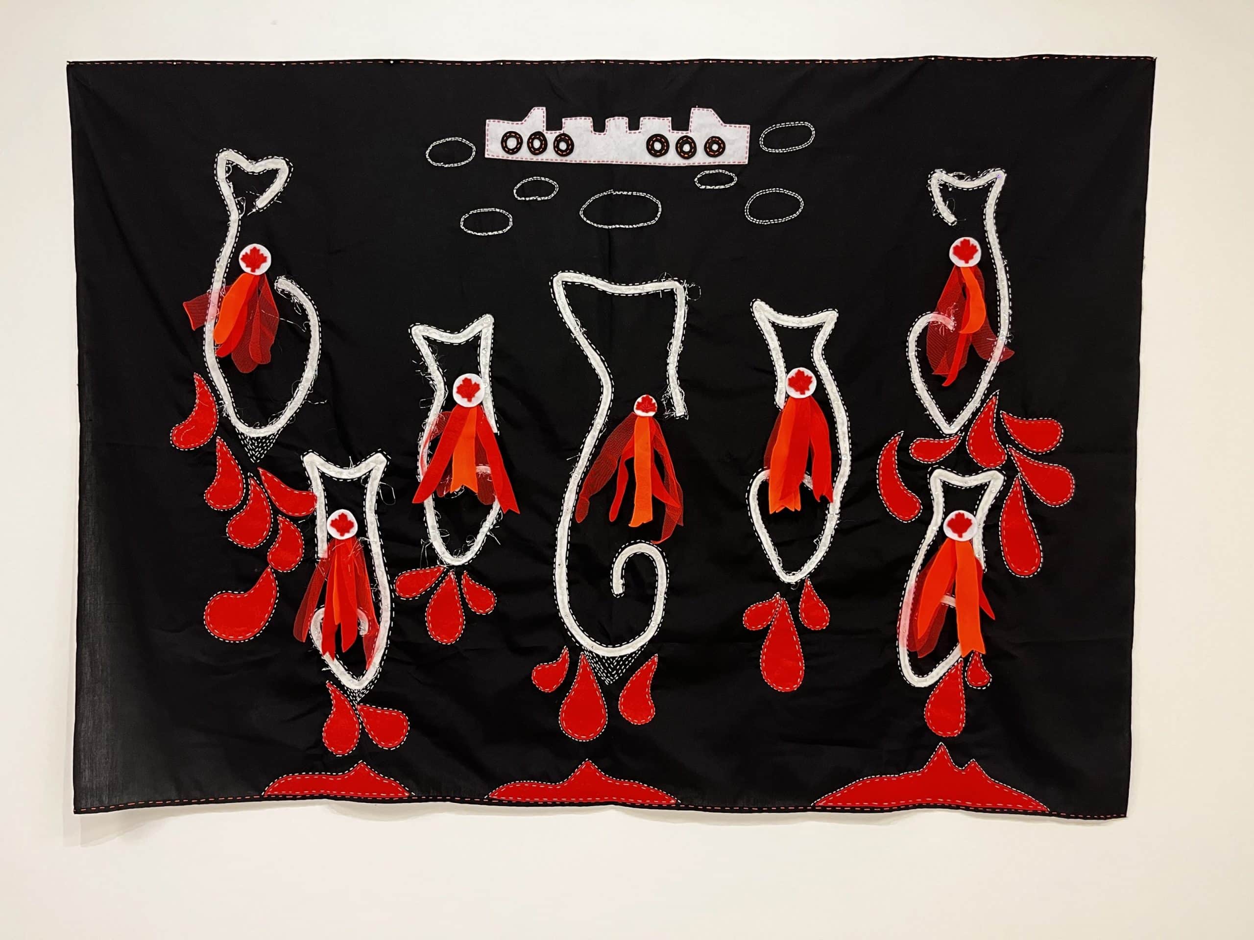 An arpillera with a black background. The shape of seven fish, oriented with their tails up are outlined in white fabric with white stitches.