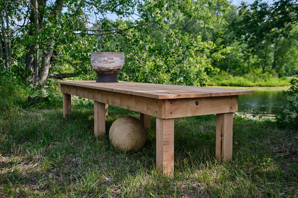 Andy Berg,Etheric Interlude, 2023, found objects, coil-built clay objects, local eastern white cedar field table