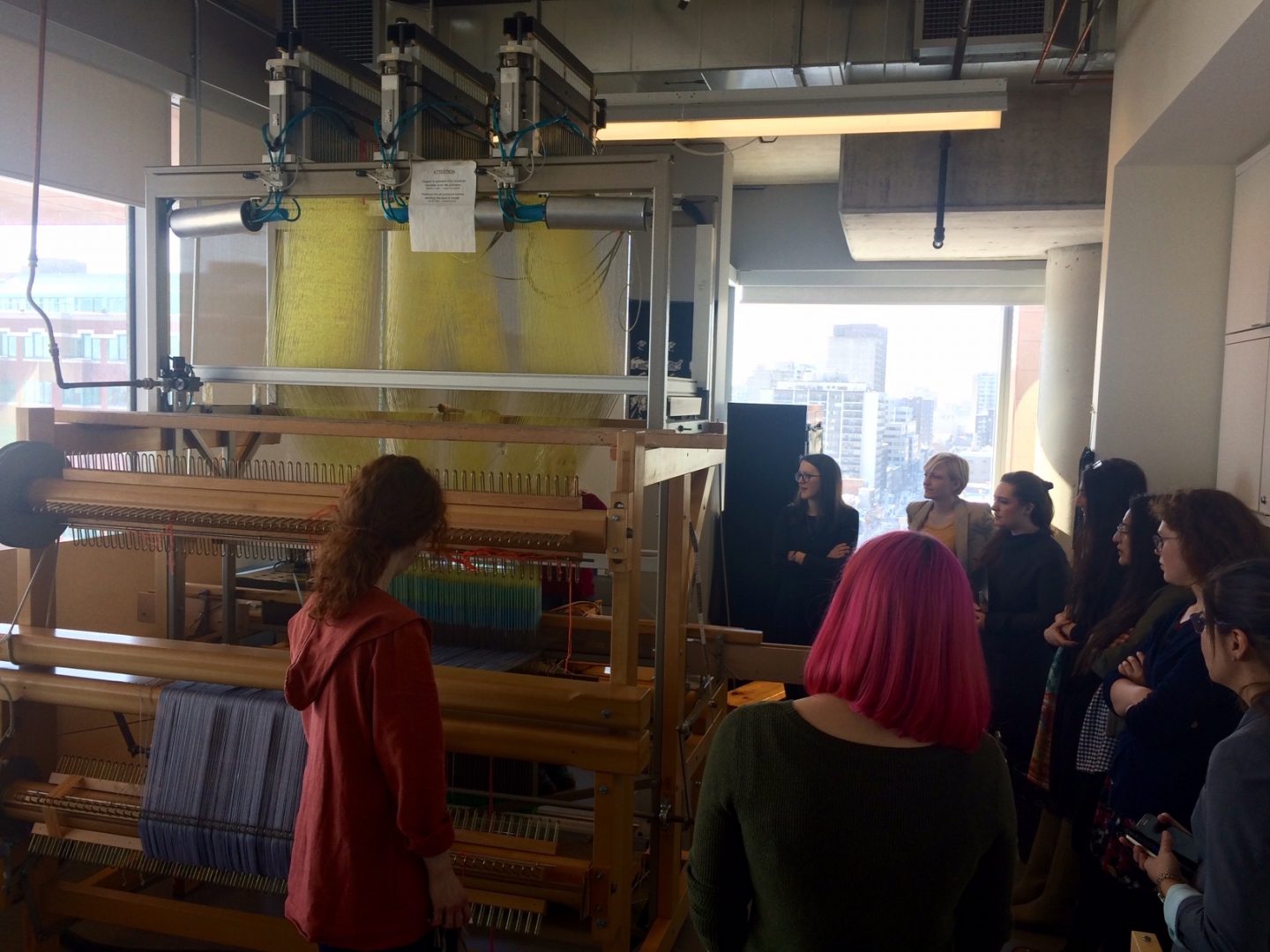 Geneviève Moisan and Claire Nadon demonstrate the Jacquard loom in the Textiles and Materiality Cluster at the Concordia Milieux Institute.