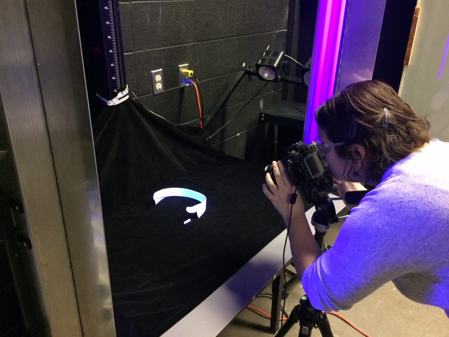 Gennifer taking a photograph of a collar under UV light.