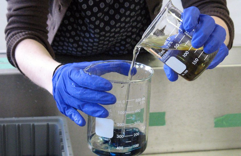 Mixing Prussian blue dye to use as a bluing agent. Prussian blue is formed when iron (III) nitrate and potassium ferrocyanide are combined. The dye was added to a rinse bath to create a very dilute solution of bluing that helps whites appear whiter after washing.