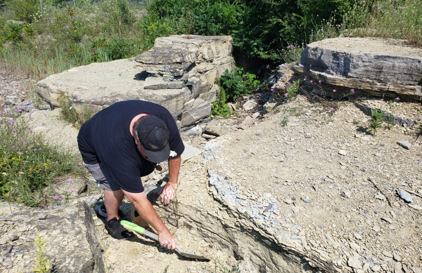 Artist Sheldon Traviss conducting artistic research at limestone quarry on 23 July 2023 in Kingston, ON.