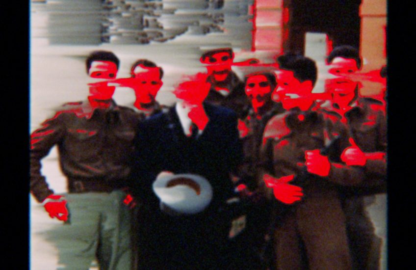 Digitized group photo with red smears covering the subject's faces