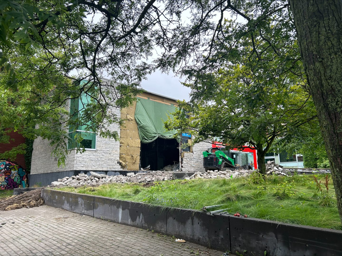 large hole in the facade of Agnes during the demolition