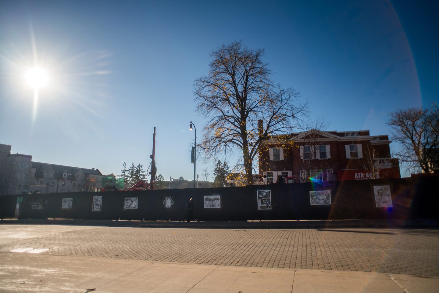 billboards in front of a construction site. The billboards have prints on them.