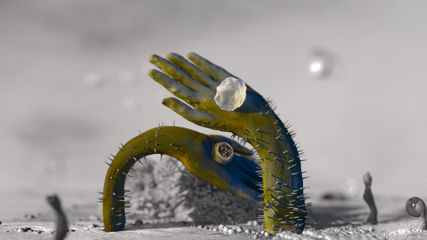 sculpture of small hand reaching and curving out of the ground.